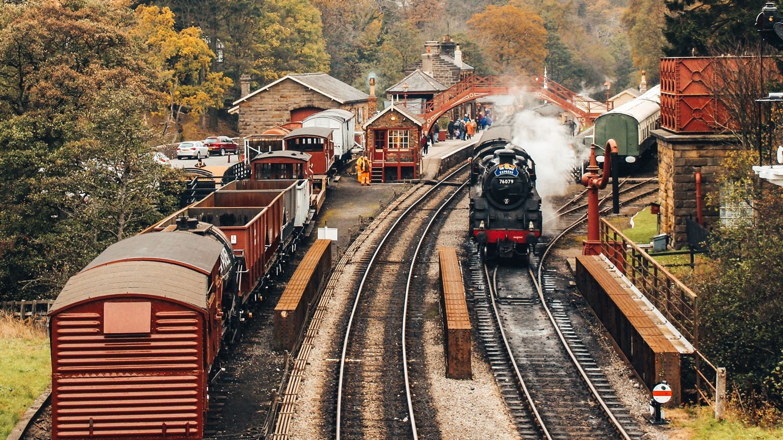 Steam train leaving a train station